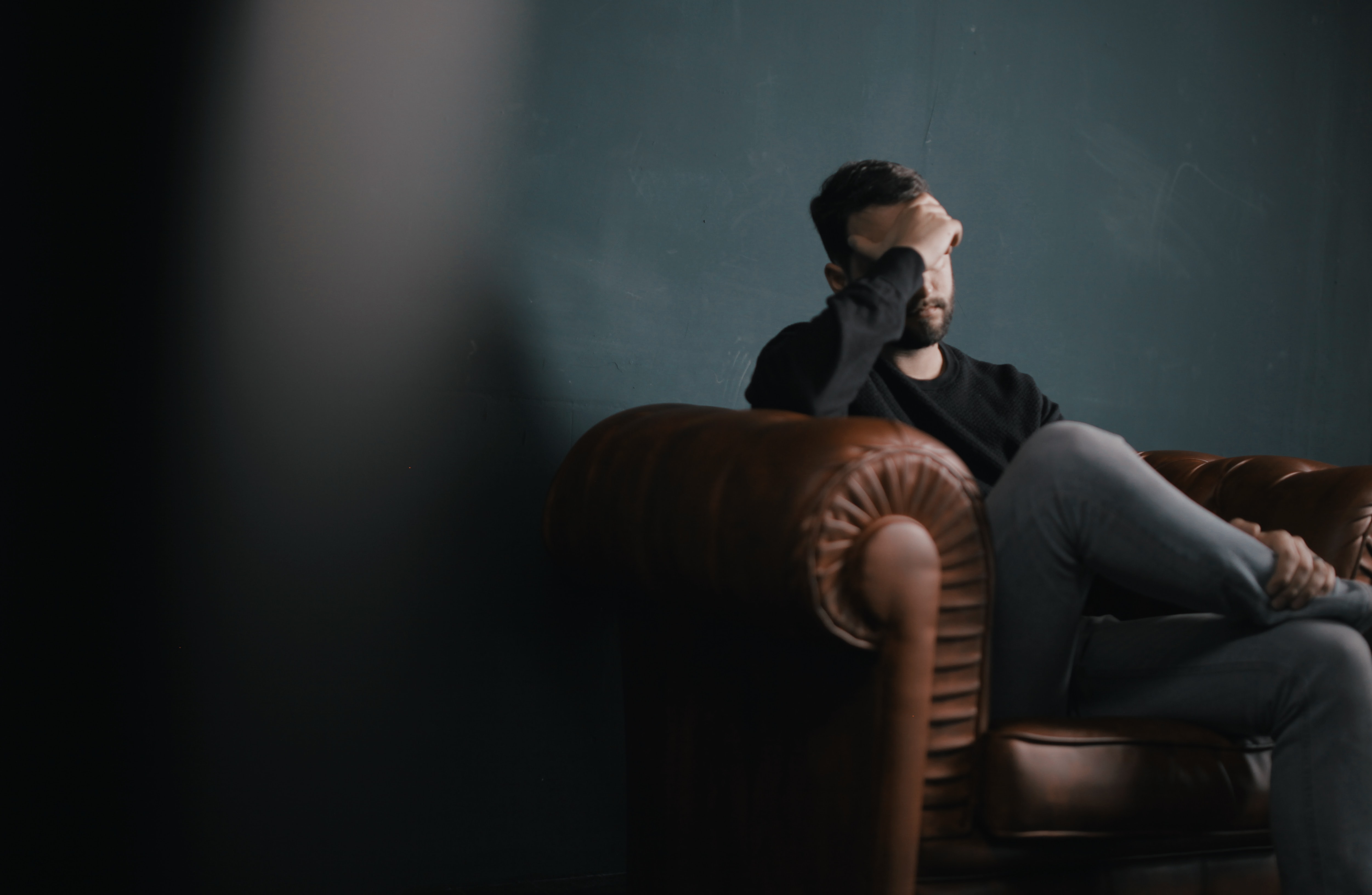 frustrated-man-sitting-on-leather-couch