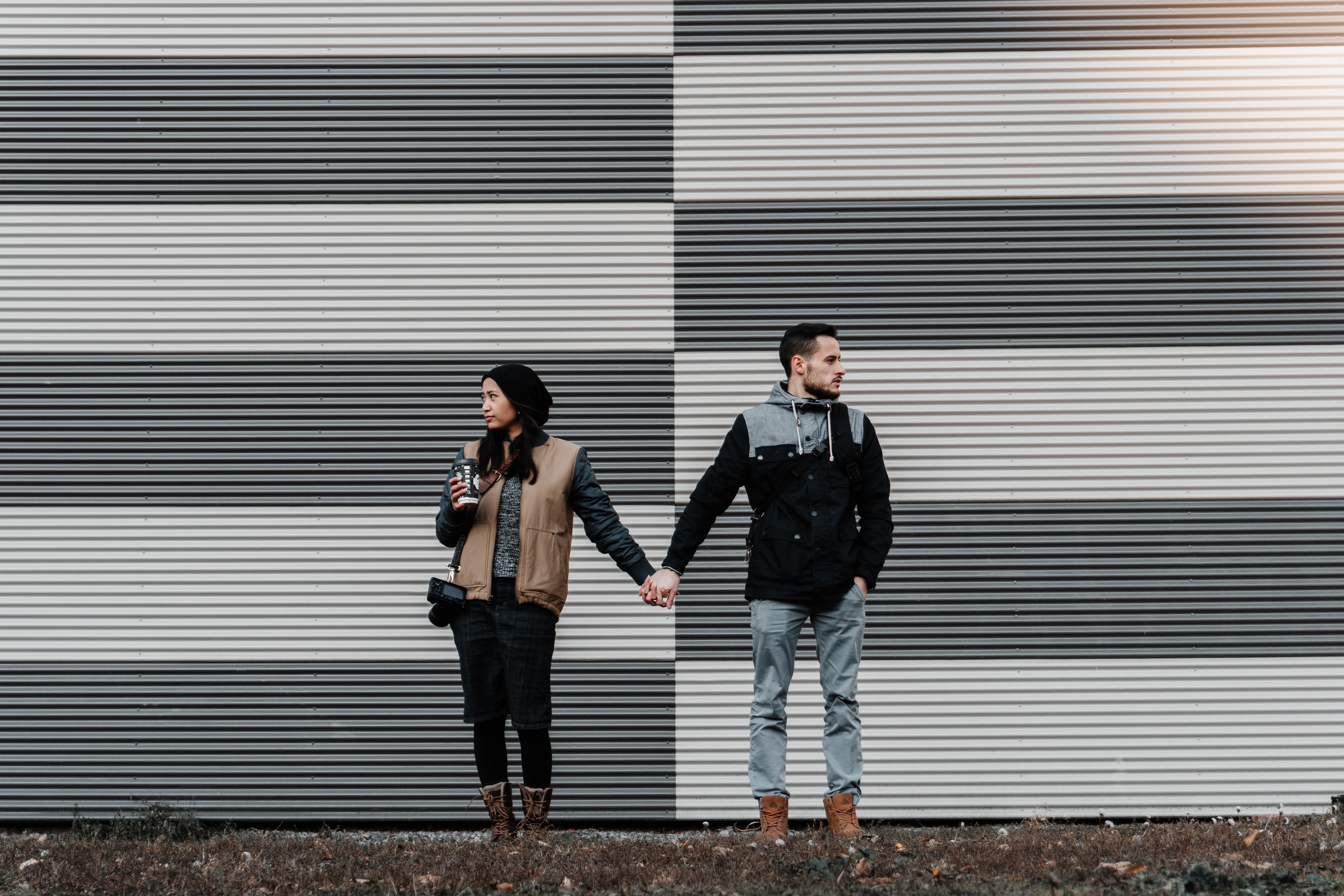 couple-holding-hands-looking-away