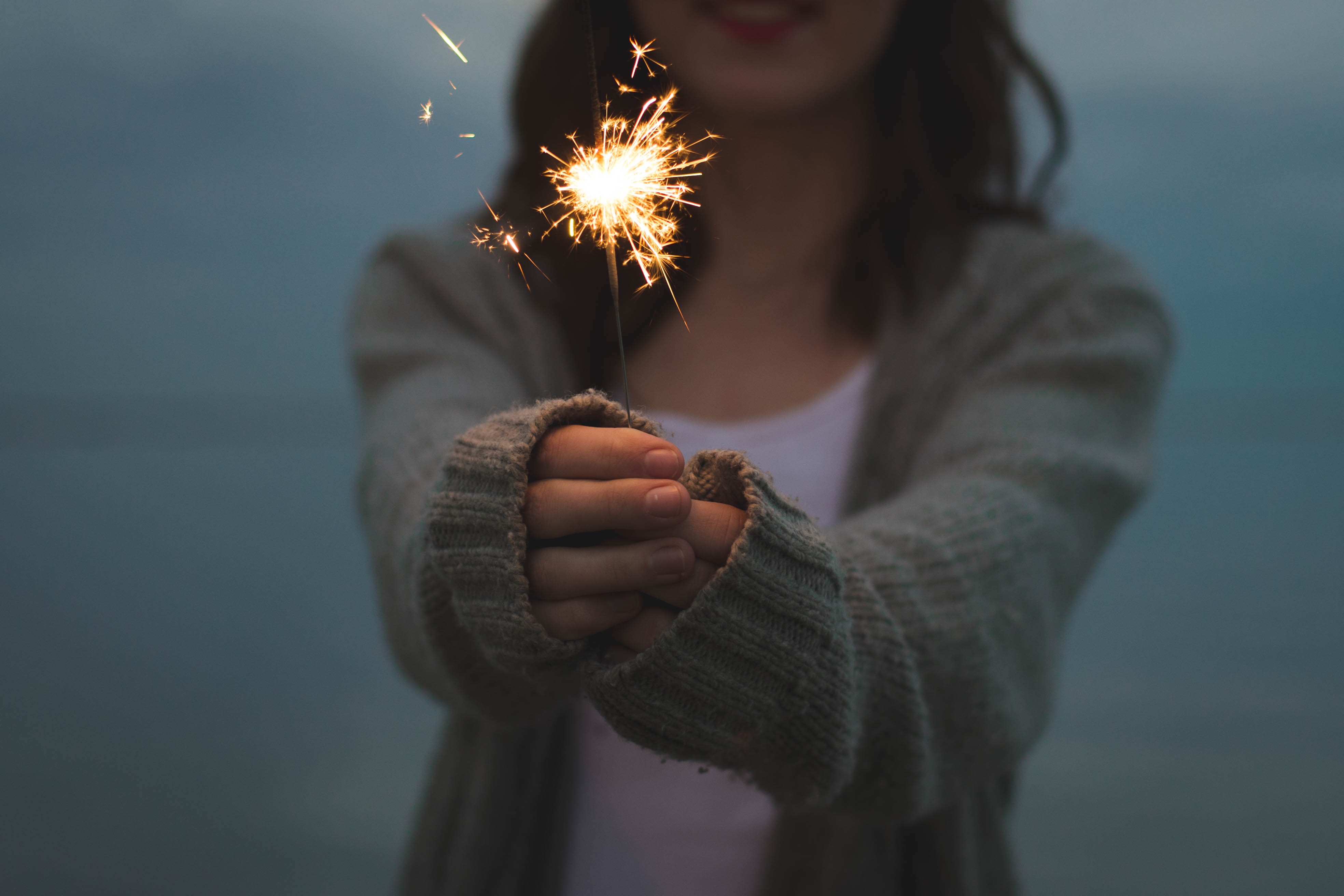 woman-in-cardigan-holding-sparkler