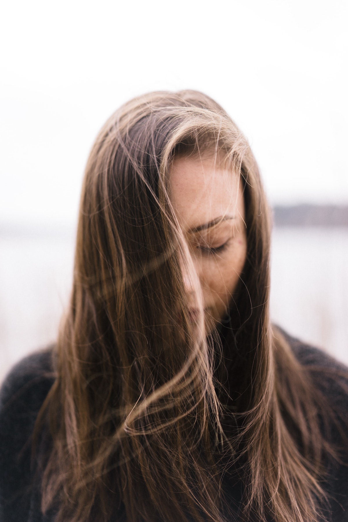 woman-with-long-hair-looking-down